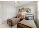 Bedroom with two twin beds and decorative wall hangings and closet at 12352 Auburndale Ct, Venice, FL 34293