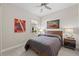 Cozy bedroom showcasing neutral tones, a ceiling fan, and ambient lighting at 12352 Auburndale Ct, Venice, FL 34293