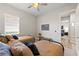 Bright bedroom with two twin beds and view to adjoining bedroom at 12352 Auburndale Ct, Venice, FL 34293