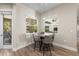 Cozy breakfast nook featuring a round table and backyard views through bright windows at 12352 Auburndale Ct, Venice, FL 34293
