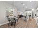 Bright breakfast nook with a round table and seamless views of the kitchen and living areas at 12352 Auburndale Ct, Venice, FL 34293