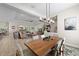 Open-concept dining area with modern lighting fixture, open to the living room at 12352 Auburndale Ct, Venice, FL 34293