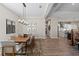 Dining room with modern chandelier, art, and wooden table at 12352 Auburndale Ct, Venice, FL 34293