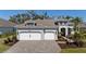 Beautiful home exterior showcasing a two-car garage, well-manicured lawn, and a welcoming entrance at 12352 Auburndale Ct, Venice, FL 34293