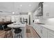 Modern kitchen with stainless steel appliances, a large island, and an open view to living area at 12352 Auburndale Ct, Venice, FL 34293