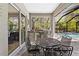 Lanai featuring an outdoor kitchen, dining table, and chairs next to the screened pool at 12352 Auburndale Ct, Venice, FL 34293