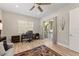 Inviting living room with a modern desk, comfortable chair, and sliding glass door to the outdoor grill area at 12352 Auburndale Ct, Venice, FL 34293