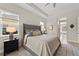 Inviting main bedroom with a king-size upholstered headboard, tray ceiling, and a view into the en suite bathroom at 12352 Auburndale Ct, Venice, FL 34293