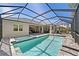 Screened in swimming pool with spa and fountains, surrounded by brick pavers and outdoor seating at 12352 Auburndale Ct, Venice, FL 34293