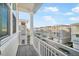 Balcony with views of the neighborhood, featuring a white railing and decking at 12413 Gulf Breeze Ter, Cortez, FL 34215