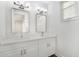 Elegant bathroom with double sinks, modern fixtures, and a large mirror at 12413 Gulf Breeze Ter, Cortez, FL 34215
