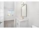 Stylish bathroom with a modern vanity, brass faucet, and a well-lit mirror at 12413 Gulf Breeze Ter, Cortez, FL 34215