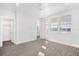 Airy bedroom with a ceiling fan, laminate flooring, natural light, and ensuite access at 12413 Gulf Breeze Ter, Cortez, FL 34215