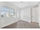 Bright bedroom featuring laminate flooring, large window with blinds, and closet at 12413 Gulf Breeze Ter, Cortez, FL 34215