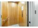 An interior view of a wood paneled elevator featuring silver accents and controls at 12413 Gulf Breeze Ter, Cortez, FL 34215
