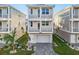 Charming three-story home featuring a two-car garage and well-manicured landscaping at 12413 Gulf Breeze Ter, Cortez, FL 34215