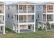 Three-story coastal home with covered parking and an outdoor seating area at 12413 Gulf Breeze Ter, Cortez, FL 34215