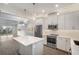 Modern kitchen with stainless steel appliances, island and stylish pendant lighting at 12413 Gulf Breeze Ter, Cortez, FL 34215