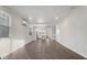 Bright open-concept living room with wood-look flooring and view of the modern kitchen at 12413 Gulf Breeze Ter, Cortez, FL 34215