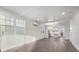 Bright open-concept living room with wood-look flooring and view of the modern kitchen at 12413 Gulf Breeze Ter, Cortez, FL 34215