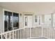 Balcony seating area with table and chairs, railing view of palm trees and buildings at 1260 Dolphin Bay Way # 404, Sarasota, FL 34242