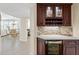 Wine bar with glass storage, wine cooler and tiled backsplash at 1260 Dolphin Bay Way # 404, Sarasota, FL 34242