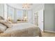 Comfortable bedroom features two windows offering plenty of natural light and a ceiling fan at 1260 Dolphin Bay Way # 404, Sarasota, FL 34242