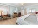 Light and airy bedroom with wood floors, a desk, and ample natural light from the shuttered window at 1260 Dolphin Bay Way # 404, Sarasota, FL 34242