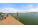 Picturesque dock with bench seating, offering stunning views of the tranquil water and distant shoreline at 1260 Dolphin Bay Way # 404, Sarasota, FL 34242