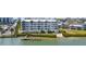 Stunning view of condo building with private beach, dock and lush landscaping on the water at 1260 Dolphin Bay Way # 404, Sarasota, FL 34242