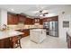 Spacious kitchen featuring granite countertops, tile backsplash, stainless steel appliances, and a central island at 1260 Dolphin Bay Way # 404, Sarasota, FL 34242