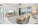 Comfortable living room with a neutral color scheme, tile flooring, and sliding glass doors to a screened patio at 1260 Dolphin Bay Way # 404, Sarasota, FL 34242