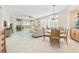 Bright living room with tile floors, dining area, and sliding glass doors to the balcony at 1260 Dolphin Bay Way # 404, Sarasota, FL 34242