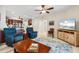 Open floor plan with chairs and furnishings plus television and view of the kitchen at 1260 Dolphin Bay Way # 404, Sarasota, FL 34242