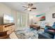 Cozy living room featuring comfortable seating, a ceiling fan, and sliding doors to the balcony at 1260 Dolphin Bay Way # 404, Sarasota, FL 34242