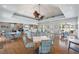 Inviting lounge with elegant seating, ceiling fans, and hardwood floors perfect for relaxing and entertaining at 1260 Dolphin Bay Way # 404, Sarasota, FL 34242