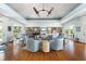 Bright and open lounge area with comfortable seating, stylish decor, and beautiful hardwood floors at 1260 Dolphin Bay Way # 404, Sarasota, FL 34242