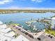 Picturesque marina view with boats docked, palm trees, tennis court, and surrounding neighborhood at 1260 Dolphin Bay Way # 404, Sarasota, FL 34242