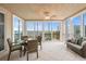 Outdoor patio area boasting full sliding glass windows, ceiling fan, dining table, and lovely marina views at 1260 Dolphin Bay Way # 404, Sarasota, FL 34242