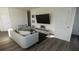 Stylish living room featuring hardwood floors, contemporary furniture, and an entertainment center at 13042 Bayberry Way, Parrish, FL 34219