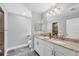 Bathroom featuring double vanity sinks with granite counters and tiled floors at 145 Baytree Dr, Rotonda West, FL 33947