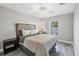 Cozy bedroom with a comfortable bed, ceiling fan, and a view of the outdoors at 145 Baytree Dr, Rotonda West, FL 33947