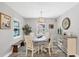 Charming dining room featuring wood floors, a modern light fixture, and views of the backyard at 145 Baytree Dr, Rotonda West, FL 33947