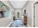 Bright hallway featuring light gray walls, a starfish rug, and stylish decor creating an inviting space at 145 Baytree Dr, Rotonda West, FL 33947