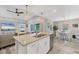 Bright kitchen features granite counters and stainless steel appliances with an adjacent breakfast nook and living area at 145 Baytree Dr, Rotonda West, FL 33947