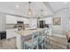 Bright kitchen with granite countertops, a stainless steel refrigerator, and island seating at 145 Baytree Dr, Rotonda West, FL 33947