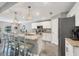 Bright kitchen features granite counters, a central island with seating, and stainless steel appliances at 145 Baytree Dr, Rotonda West, FL 33947