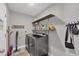 Well-organized laundry room with modern washer and dryer, floating shelves, and stylish decor at 145 Baytree Dr, Rotonda West, FL 33947