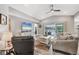 Spacious living room with a modern ceiling fan and sliding glass doors leading to an outdoor patio at 145 Baytree Dr, Rotonda West, FL 33947