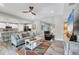 Spacious living room with gray wood flooring and neutral paint colors leading into the open-concept kitchen at 145 Baytree Dr, Rotonda West, FL 33947